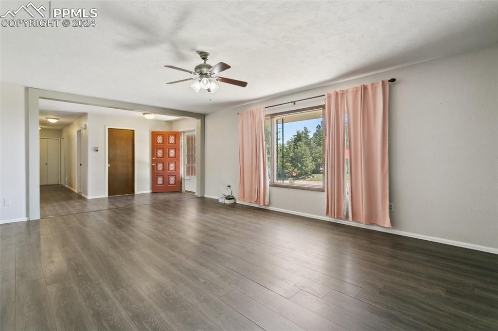 519 Dakota Avenue Simla, CO 80835 - Photo 6 of 27 a view of an empty room with wooden floor and a window