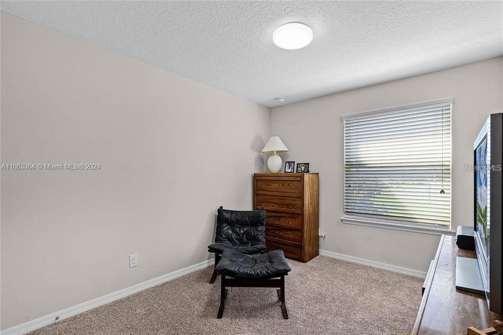 11819 Vermillion Avenue Windermere, FL 34786 - Photo 11 of 25 a room with a chair and a window