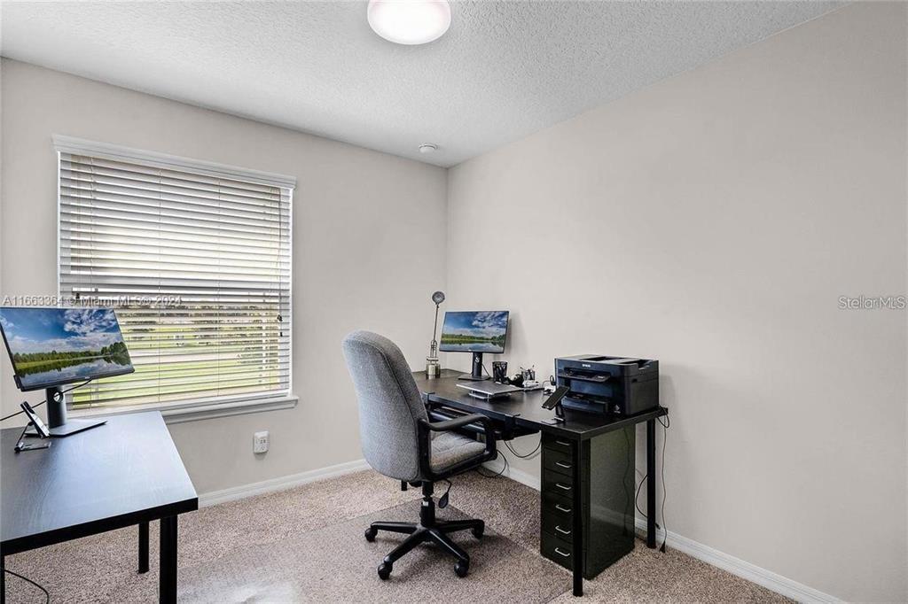 11819 Vermillion Avenue Windermere, FL 34786 - Photo 13 of 25 a view of a workspace with furniture and a window