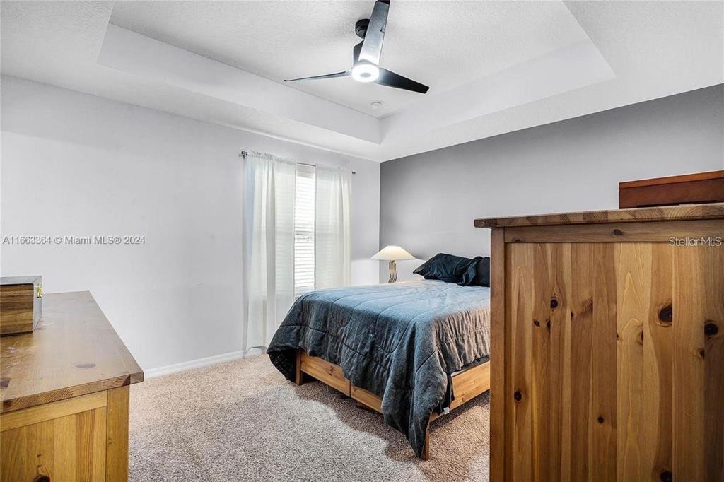 11819 Vermillion Avenue Windermere, FL 34786 - Photo 15 of 25 a bedroom with a bed and a dresser