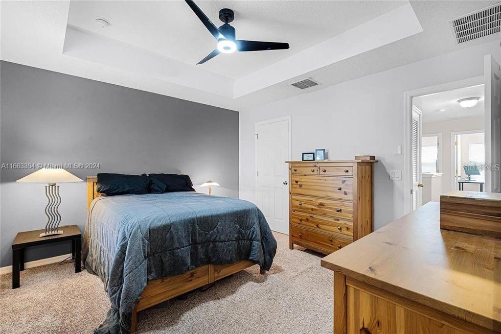 11819 Vermillion Avenue Windermere, FL 34786 - Photo 17 of 25 a bedroom with a bed and dresser