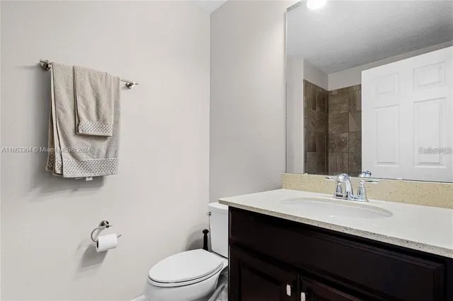 a bathroom with a double vanity sink toilet and shower