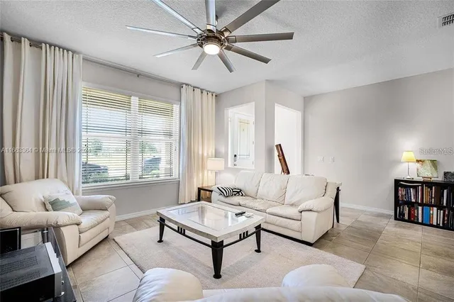 a living room with furniture a bed and a window