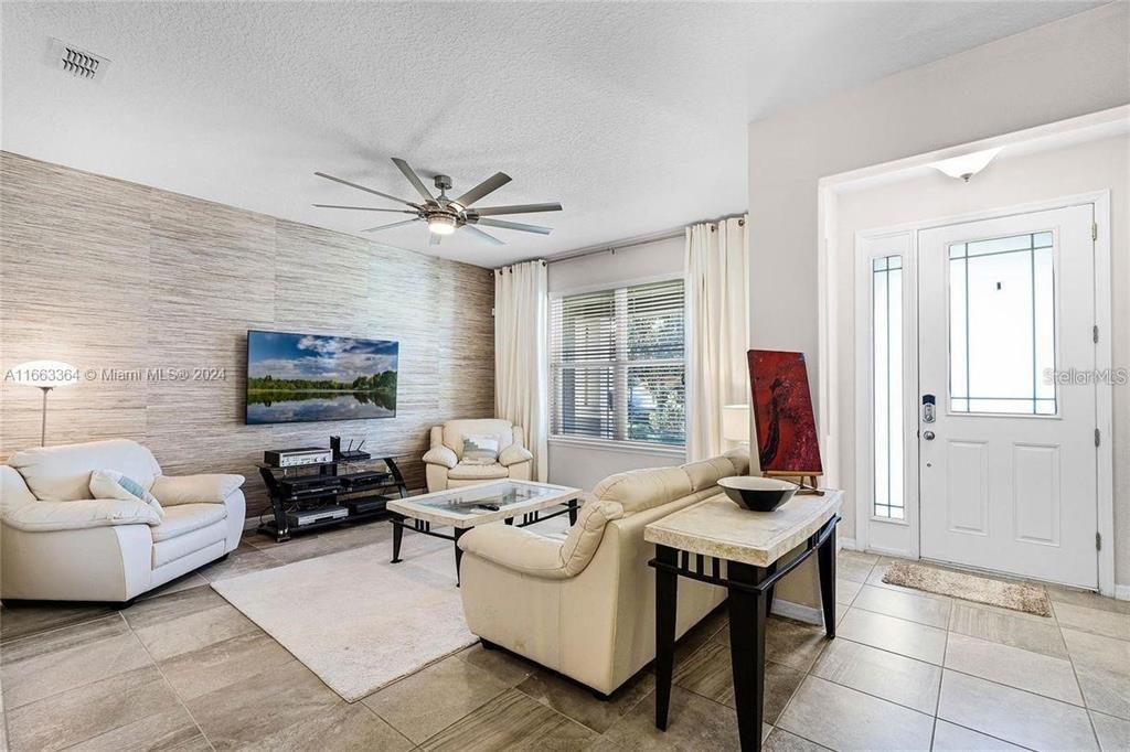 11819 Vermillion Avenue Windermere, FL 34786 - Photo 4 of 25 a living room with furniture and a large window