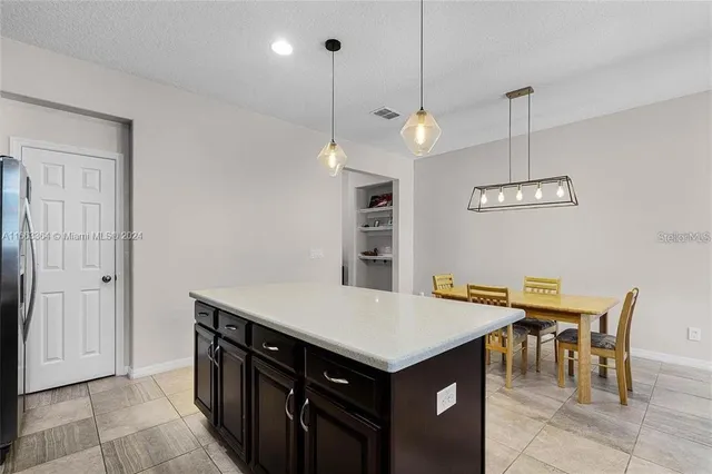 an open kitchen with a table and chairs