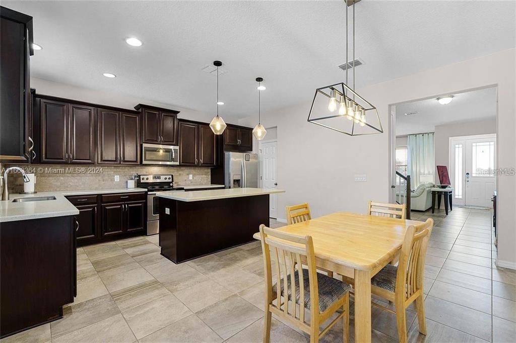 11819 Vermillion Avenue Windermere, FL 34786 - Photo 7 of 25 a kitchen with a sink a counter space appliances and cabinets