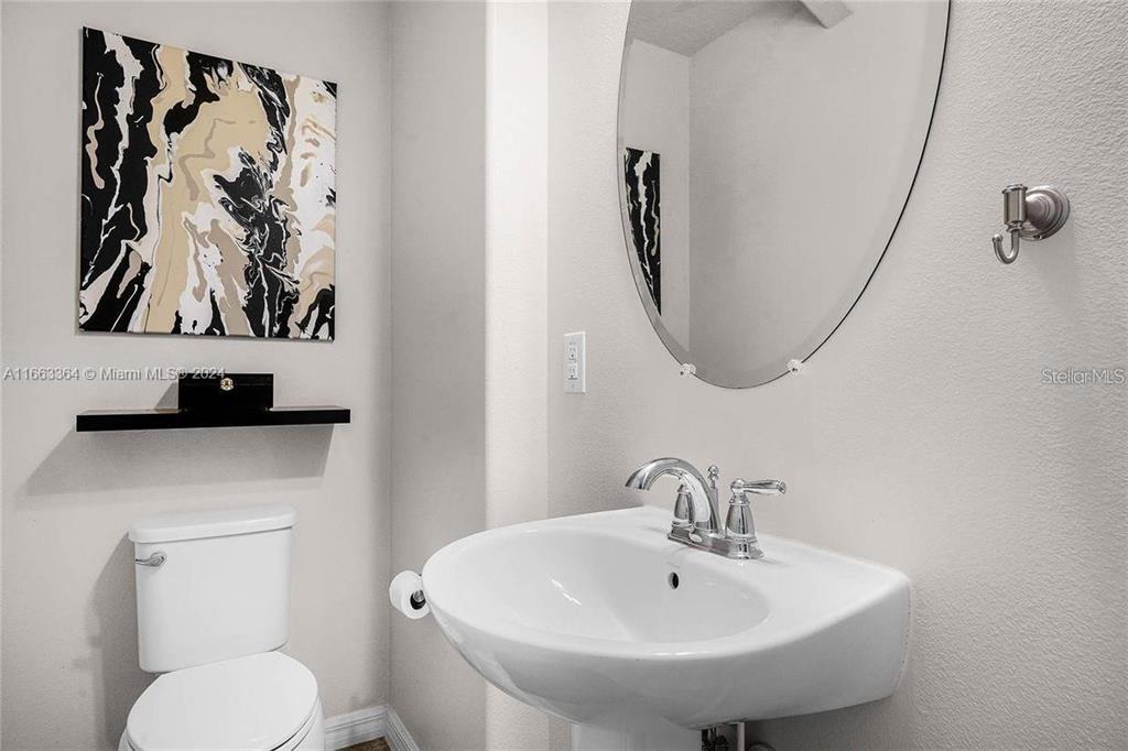 11819 Vermillion Avenue Windermere, FL 34786 - Photo 9 of 25 a bathroom with a toilet and sink