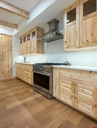 a hallway with painting on the wall and a mirror