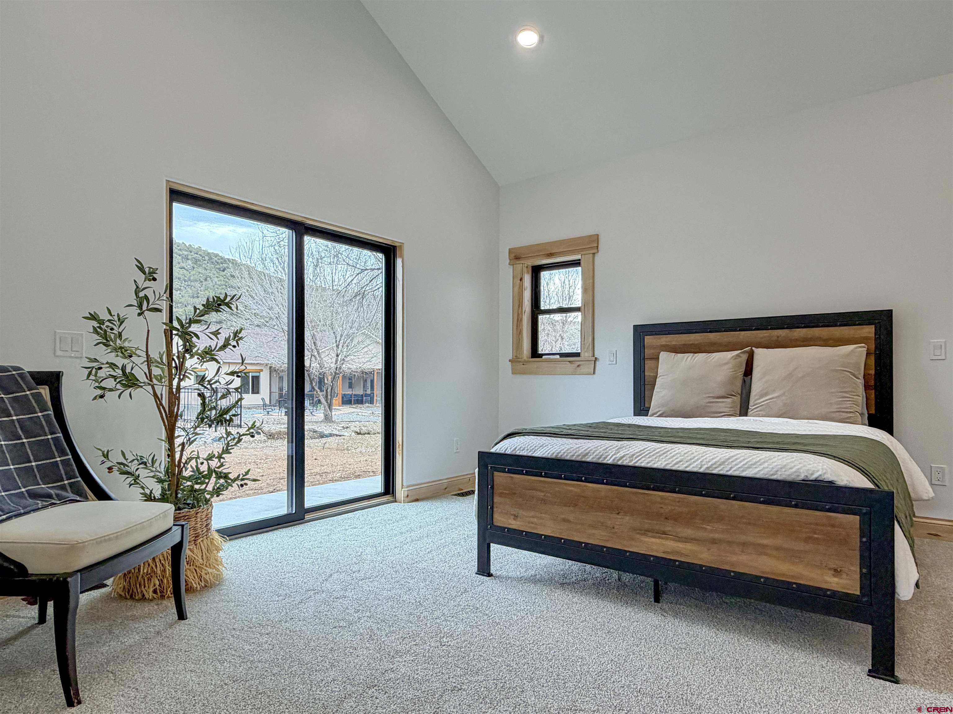 805 Southeast Pinyon Street Cedaredge, CO 81413 - Photo 23 of 45 a bedroom with a bed and a table