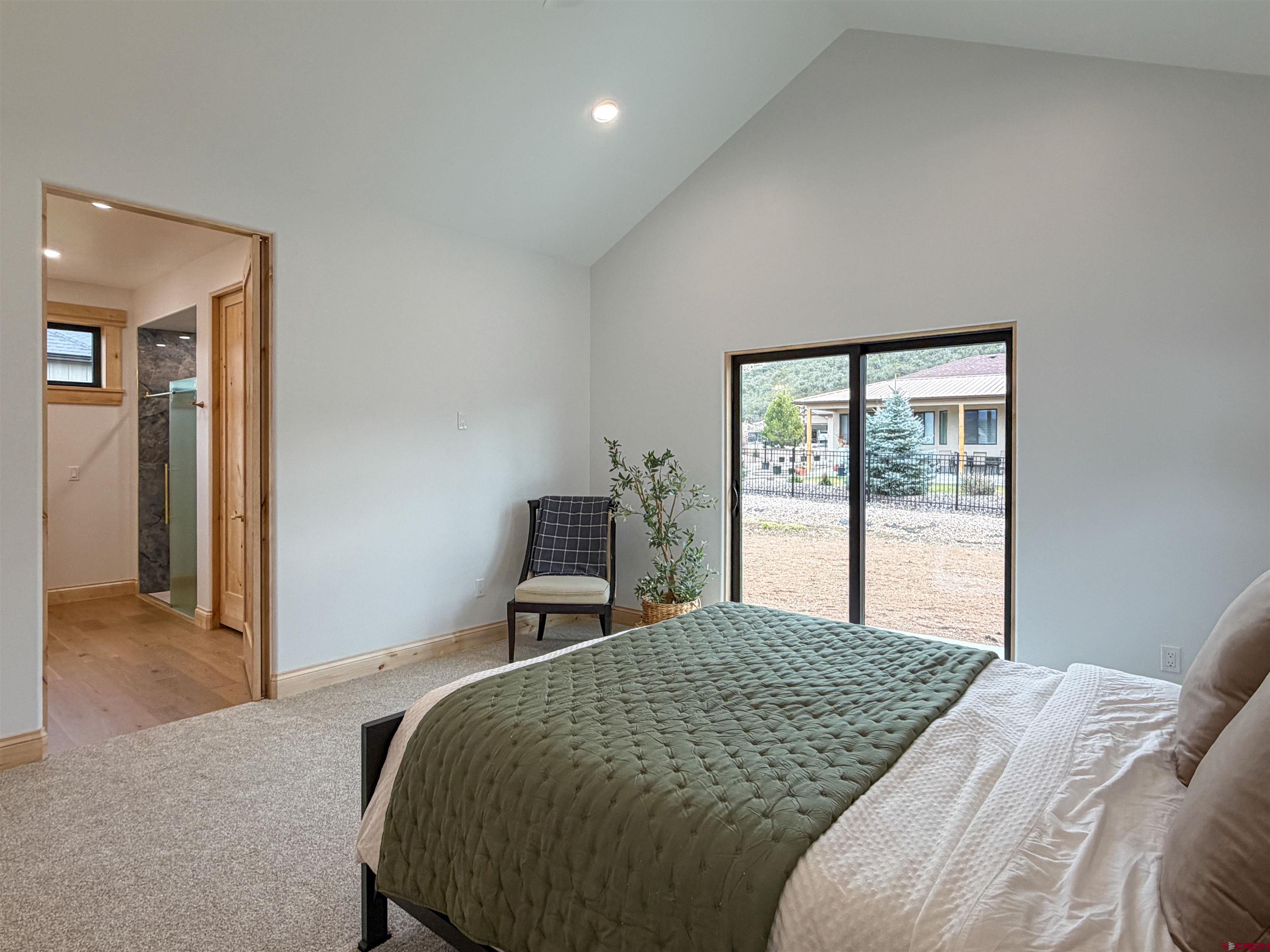 805 Southeast Pinyon Street Cedaredge, CO 81413 - Photo 24 of 45 a bedroom with a bed and a window