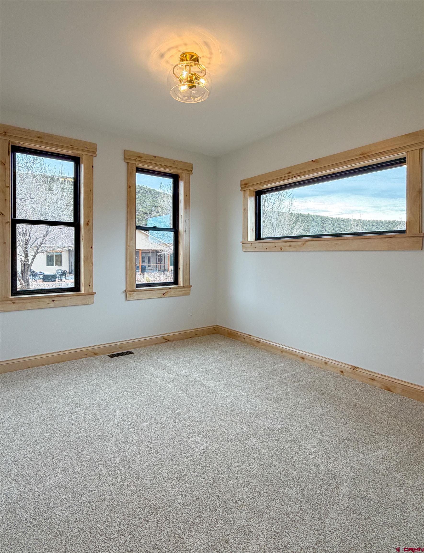 805 Southeast Pinyon Street Cedaredge, CO 81413 - Photo 33 of 45 a view of an empty room with a window