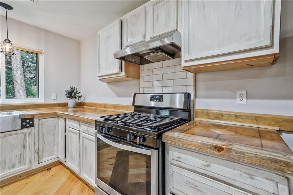 3225 Spring Drive Northwest Atlanta, GA 30360 - Photo 13 of 28 a kitchen with stainless steel appliances granite countertop a stove and a sink