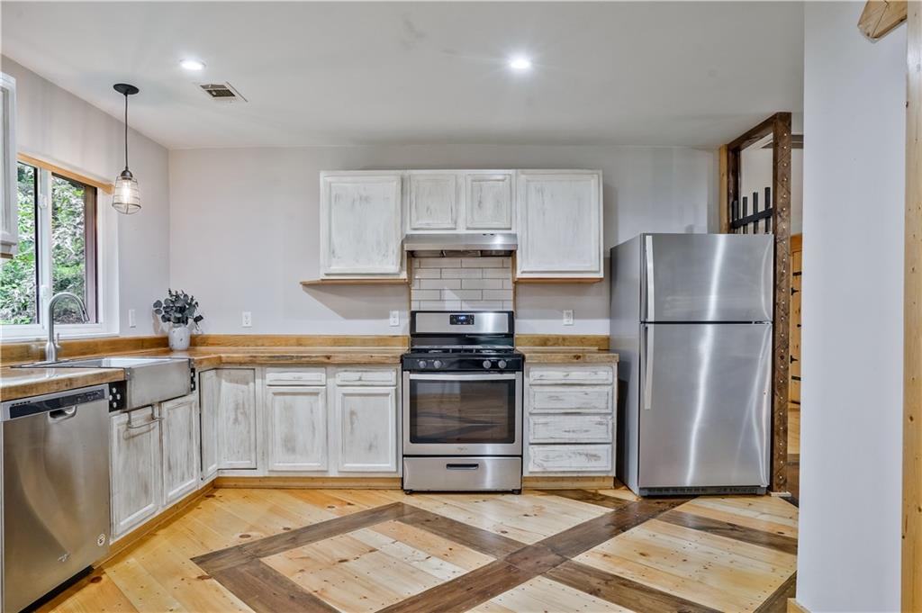 3225 Spring Drive Northwest Atlanta, GA 30360 - Photo 14 of 28 a kitchen with a refrigerator sink and cabinets