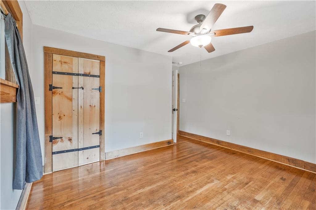 3225 Spring Drive Northwest Atlanta, GA 30360 - Photo 19 of 28 wooden floor in an empty room with a window
