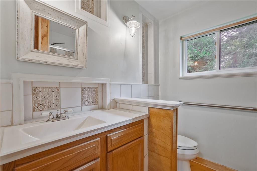 3225 Spring Drive Northwest Atlanta, GA 30360 - Photo 20 of 28 a bathroom with a sink a toilet and a mirror