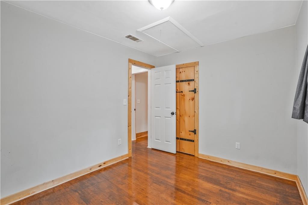 3225 Spring Drive Northwest Atlanta, GA 30360 - Photo 24 of 28 an empty room with wooden floor and closet