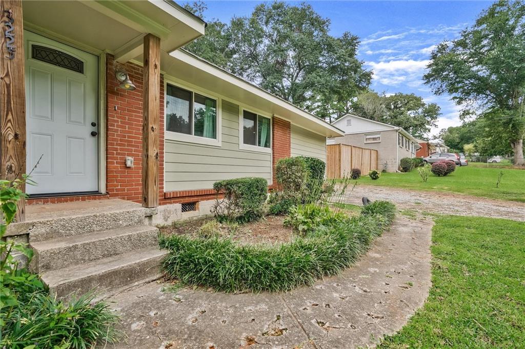3225 Spring Drive Northwest Atlanta, GA 30360 - Photo 3 of 28 a front view of a house with garden