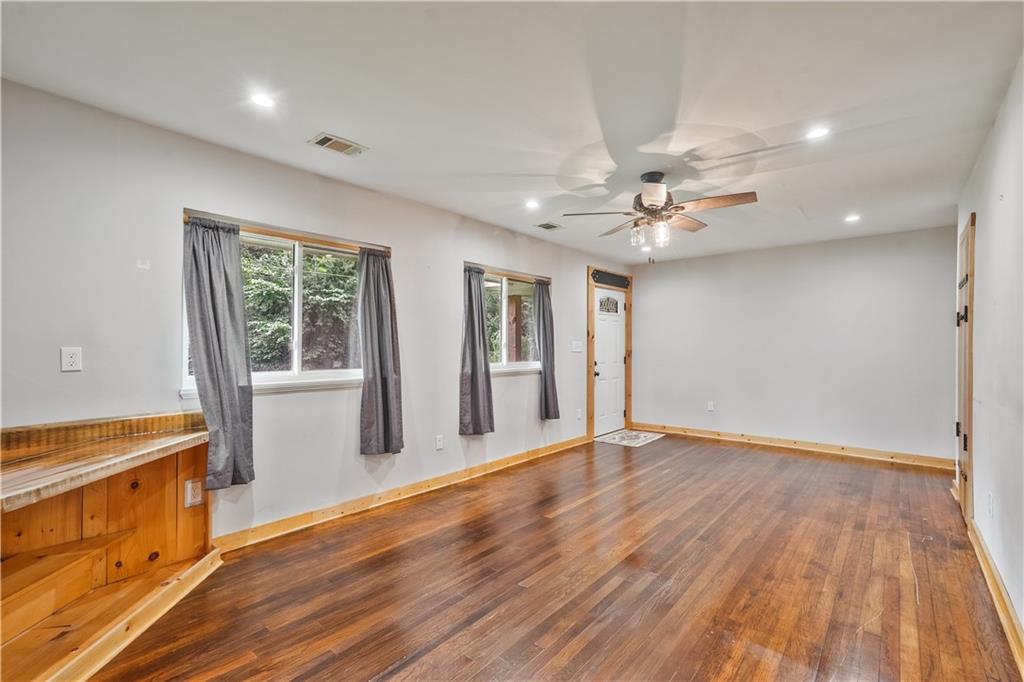 3225 Spring Drive Northwest Atlanta, GA 30360 - Photo 6 of 28 a view of an empty room with a window and wooden floor