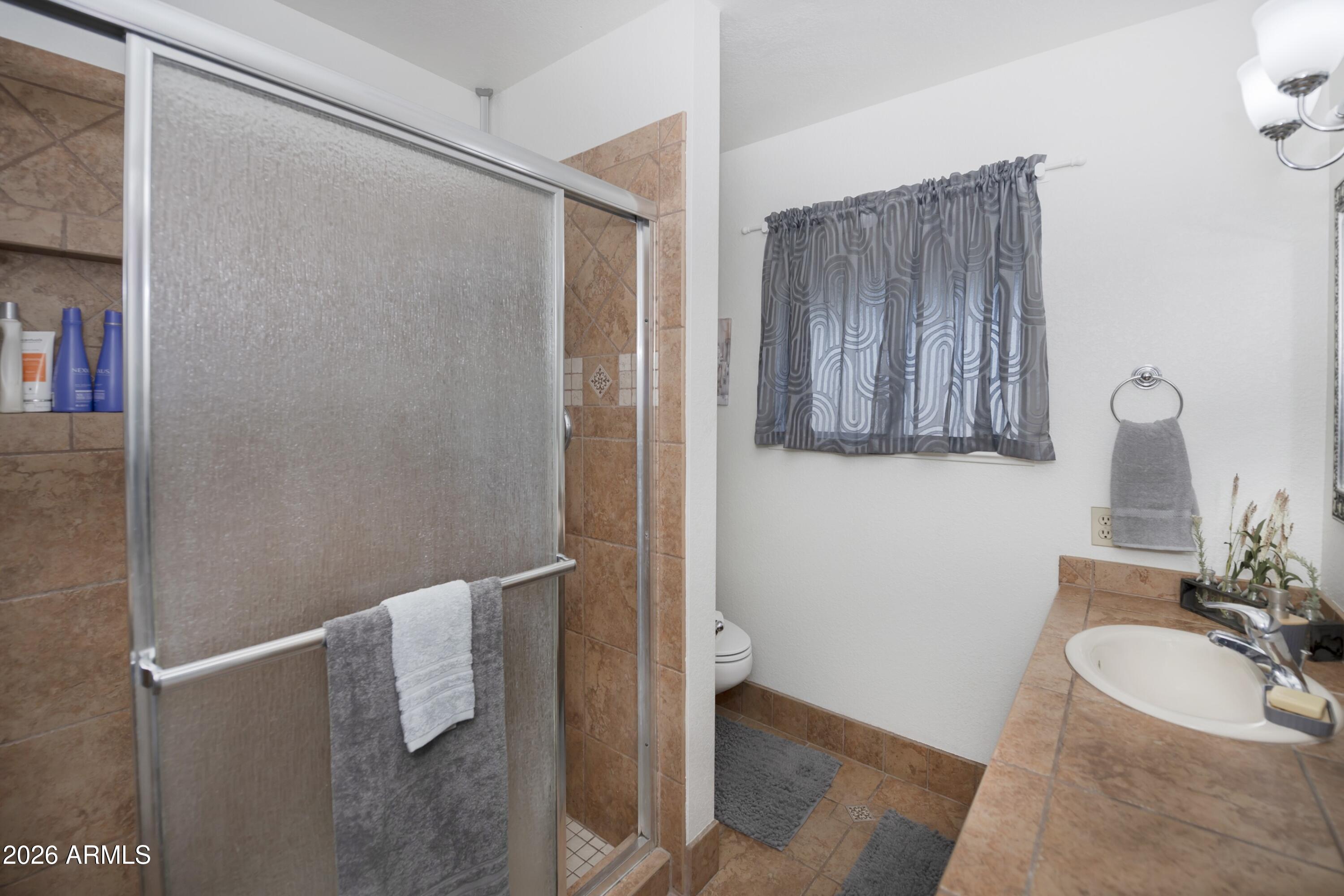 11160 Pima Road Dewey, AZ 86327 - Photo 14 of 58 a bathroom with a sink and mirror