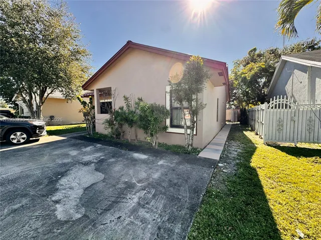 a view of house with backyard and garden