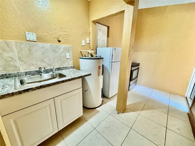 a bathroom with a sink and a washing machine