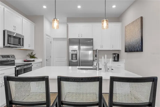 a kitchen with a sink stainless steel appliances and cabinets