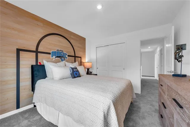 a bedroom with bed and a large window