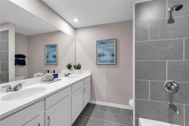 a bathroom with a double vanity sink a mirror and a shower