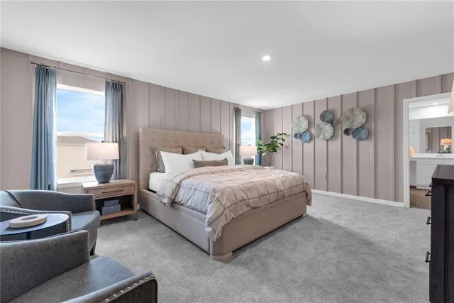 a bedroom with a bed couch and a large window