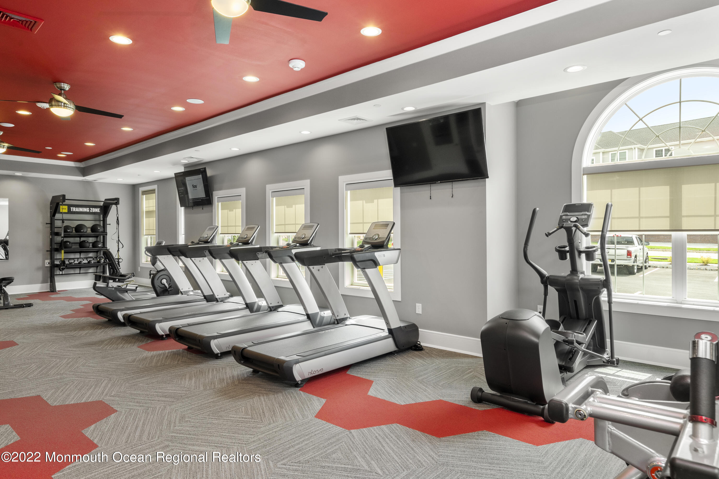 2302 Jamison Road Monroe Township, NJ 08831 - Photo 18 of 18 a living room with furniture a flat screen tv and floor to ceiling window