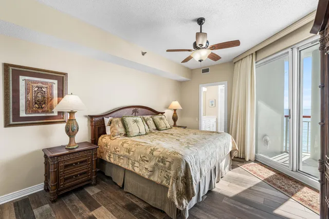 a bedroom with bed and a chandelier