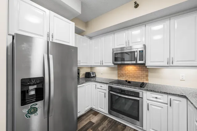 a bedroom with two beds and painting on the wall