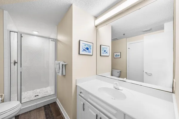 a bathroom with a shower sink and mirror