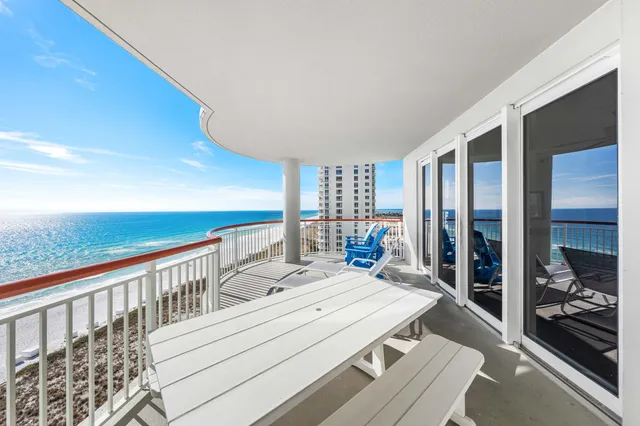 a view of a balcony with chair and the view of the balcony