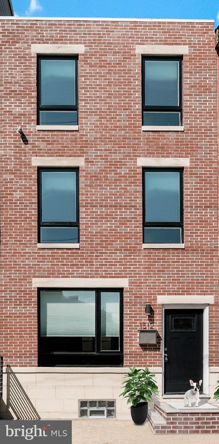 a brick house with four windows