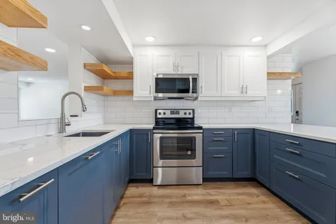 a kitchen with a sink and stainless steel appliances