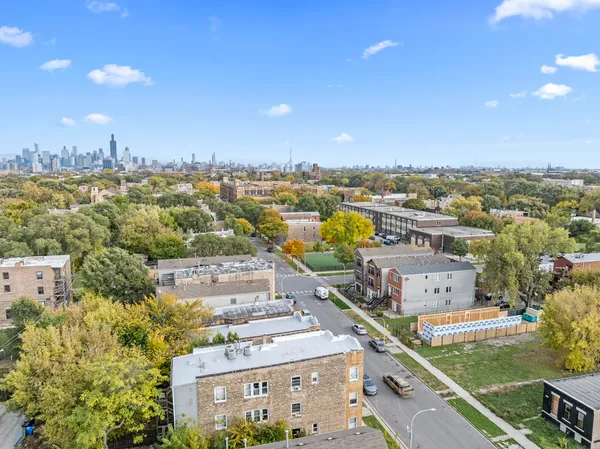 an aerial view of residential houses with city view