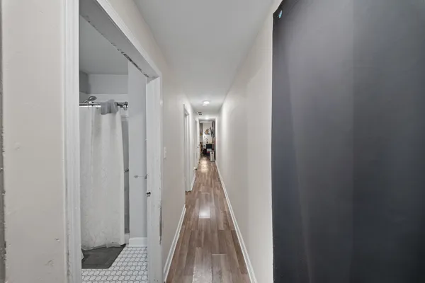 a view of hallway with wooden floor