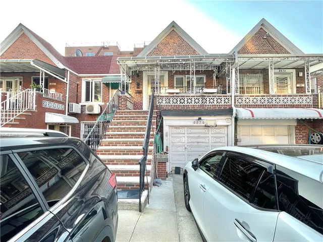 a view of a white house with a sink and a stove