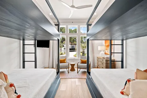 a bedroom with a large bed and a flat tv screen