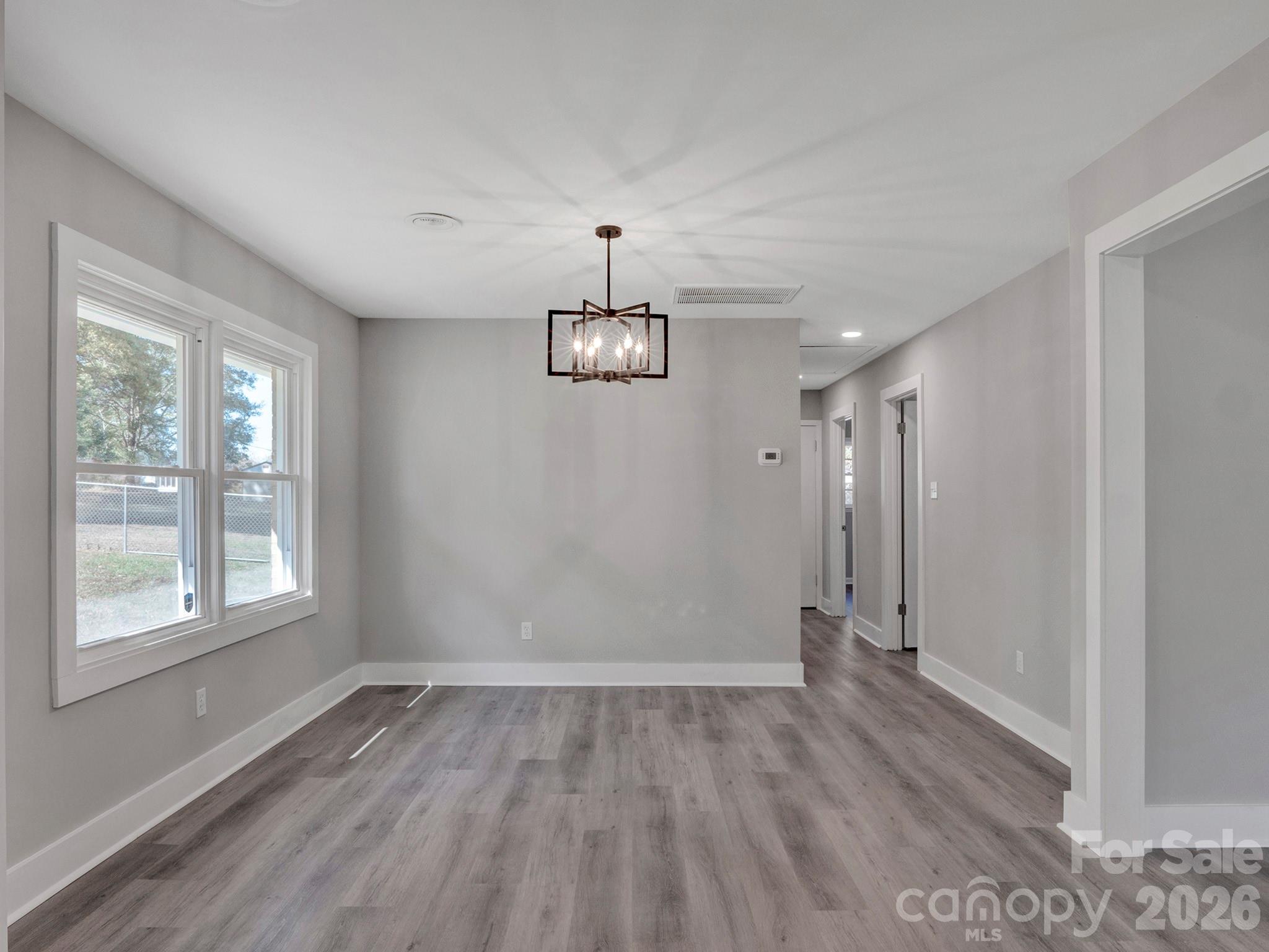 2826 State Rd S-29-656 Lancaster, SC 29720 - Photo 14 of 31 a view of an empty room with wooden floor and a window