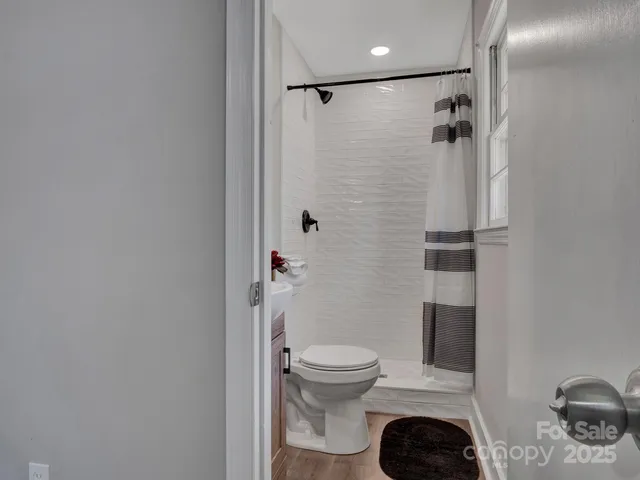 a bathroom with a toilet and a shower