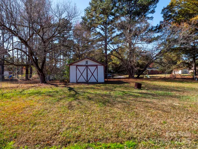 a swimming pool with outdoor seating and yard