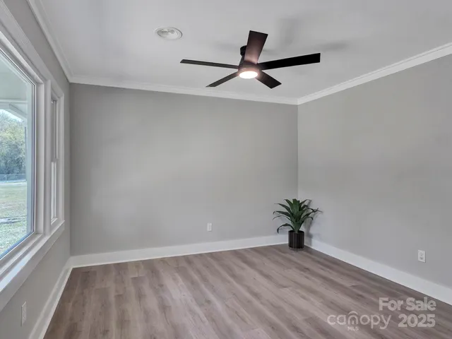 wooden floor in an empty room with a window