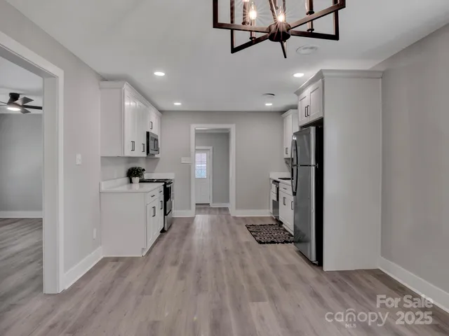 a view of a kitchen electric appliances and cabinets