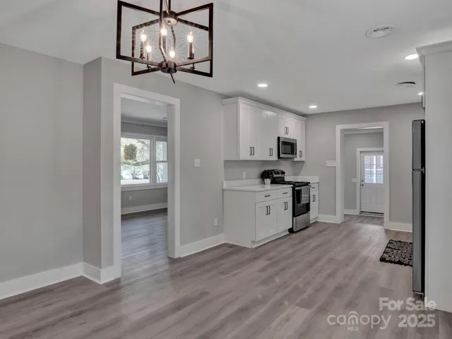 a kitchen with a refrigerator and a stove top oven