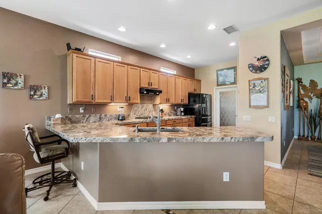 a kitchen with a stove top oven sink and cabinets