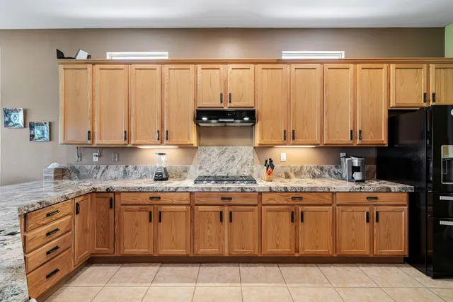 a kitchen with a sink stove and refrigerator