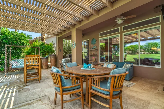a view of an outdoor dining space with furniture and yard