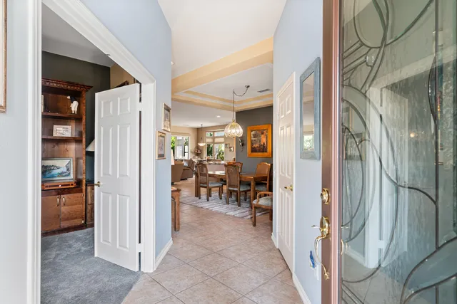 a view of a hallway with furniture and a livingroom